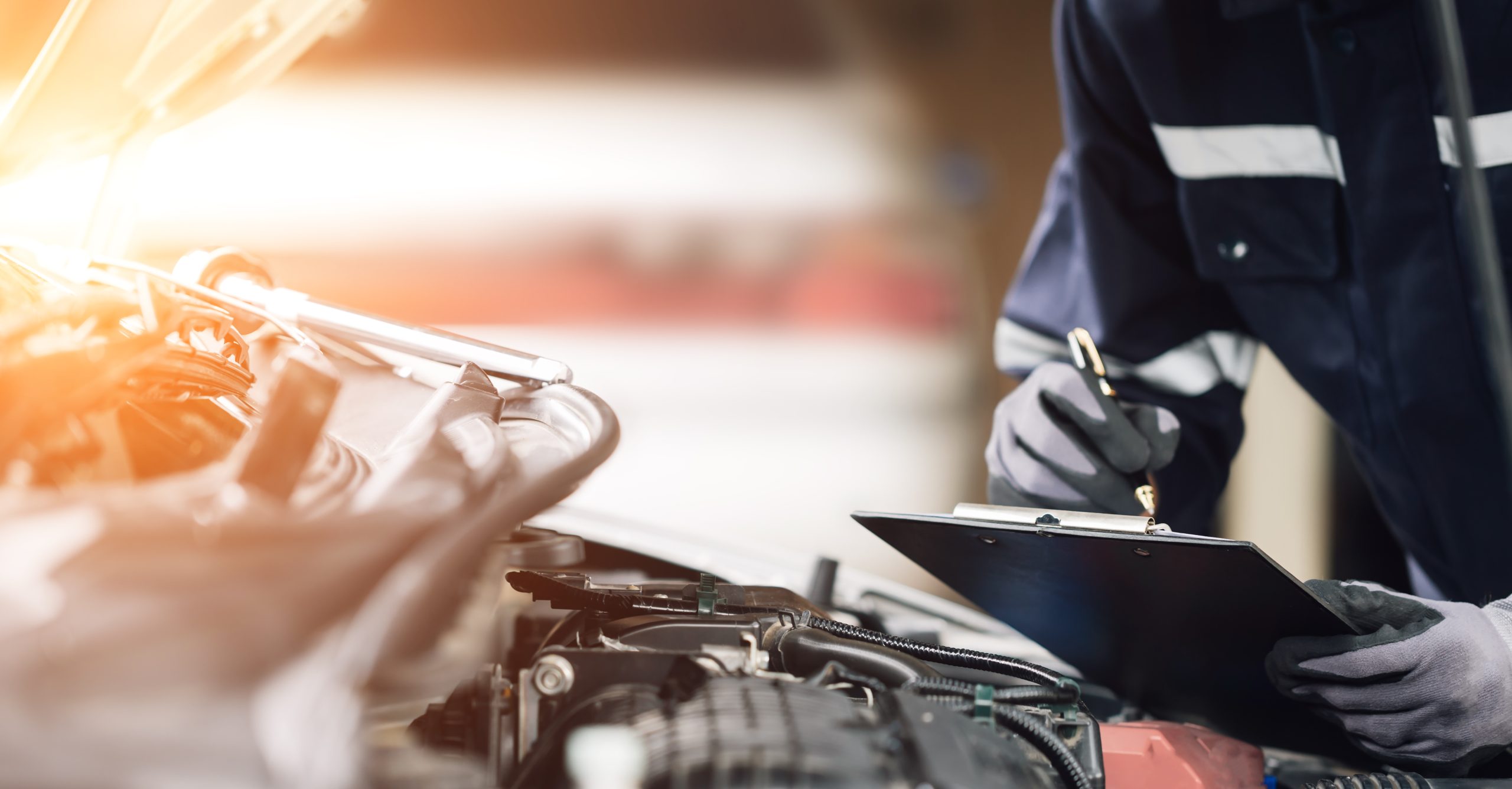 Mechanic works on the engine of the car in the garage. Repair se
